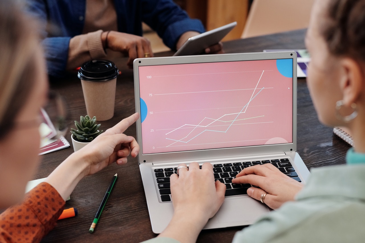 A group of architects and designers watching a digital seminar showing charts and graphs