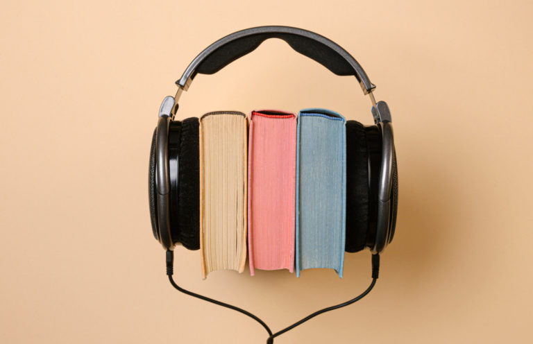 A set of headphones stretched around three books